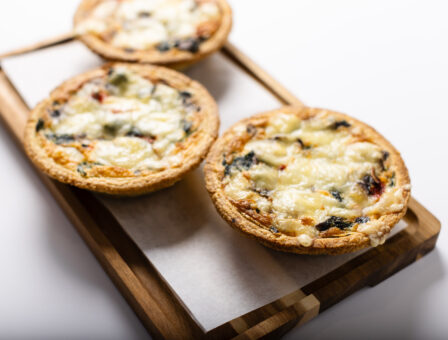 Mini quiches displayed on a serving board.