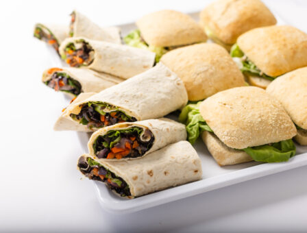 Sandwiches and wraps displayed on a platter.