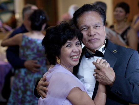 A couple dancing at a retirement party.