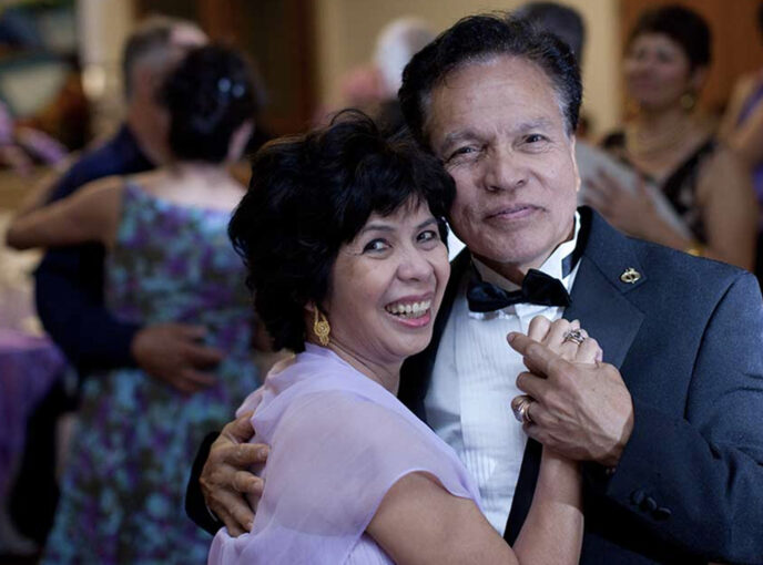 A couple dancing at a retirement party.