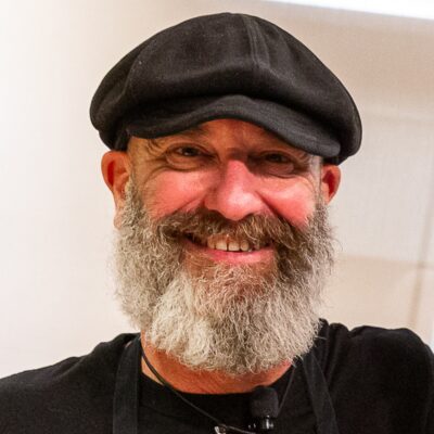 Bearded man in black cap and T-shirt