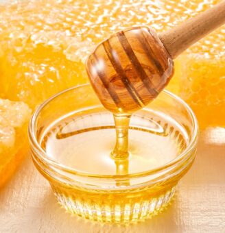 Honey dripping into a bowl from honey spinner