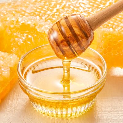 Honey dripping into a jar