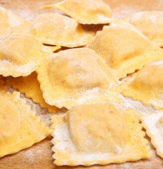 Handmade ravioli on a floured counter