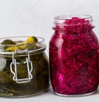 A jar of handmade pickles and a jar of pickled beets