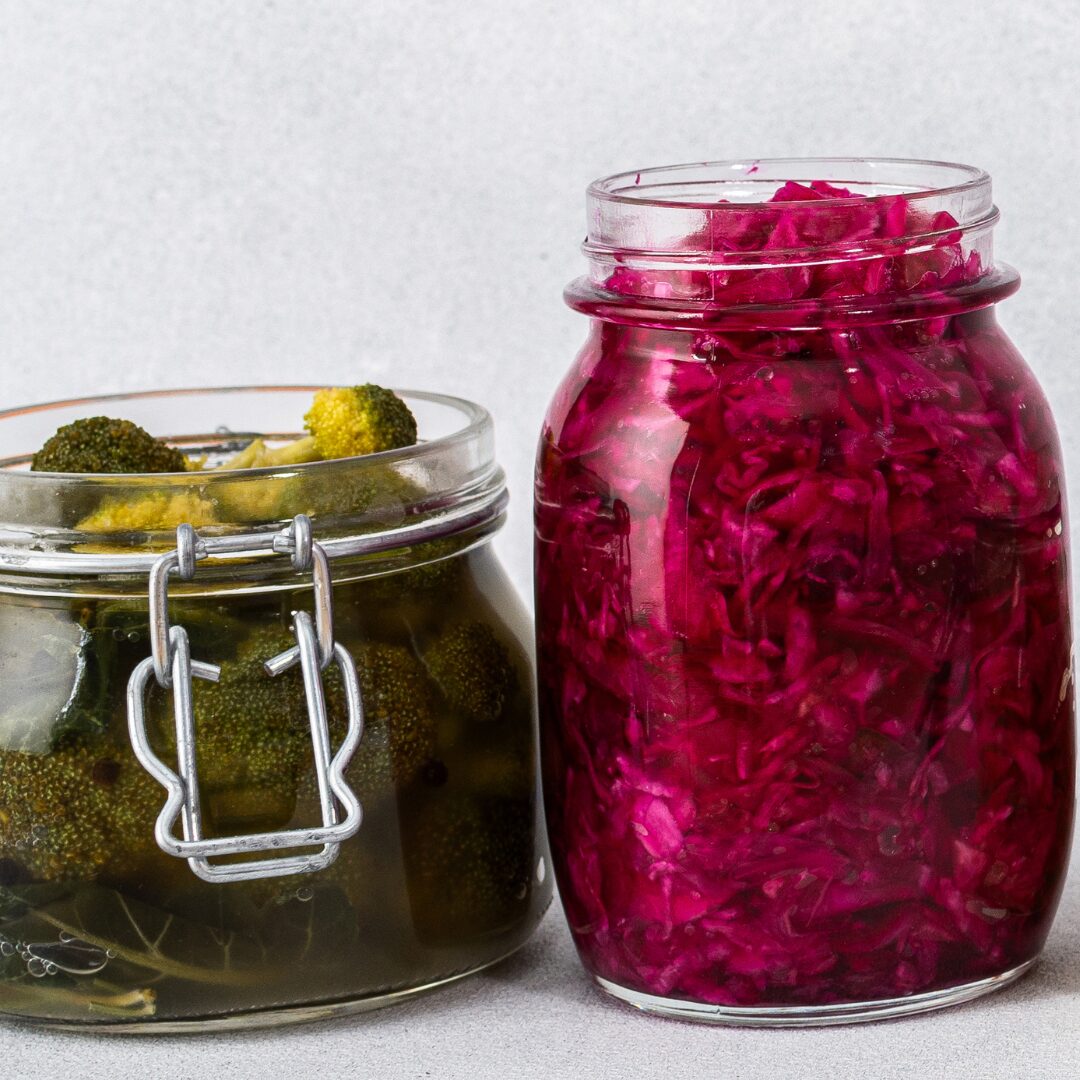 A jar of handmade pickles and a jar of pickled beets