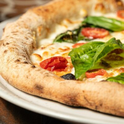 Fresh baked marinara pizza with basil leaves