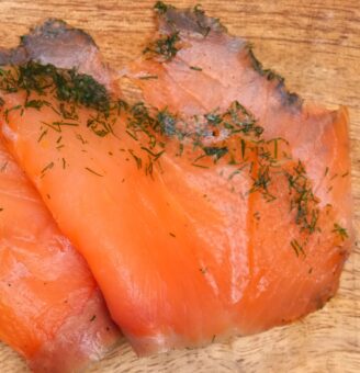 Slices of gravlax on a wooden board
