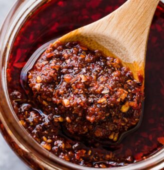 Jar of salsa macha with wooden spoon