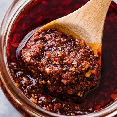 Jar of salsa macha with wooden spoon