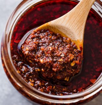 Homemade salsa in glass jar with spoon