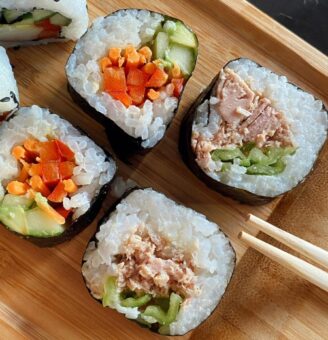 Slices of nori-wrapped sushi on a board