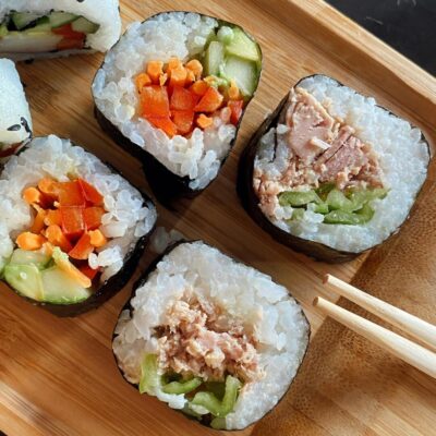 Slices of nori-wrapped sushi on a board