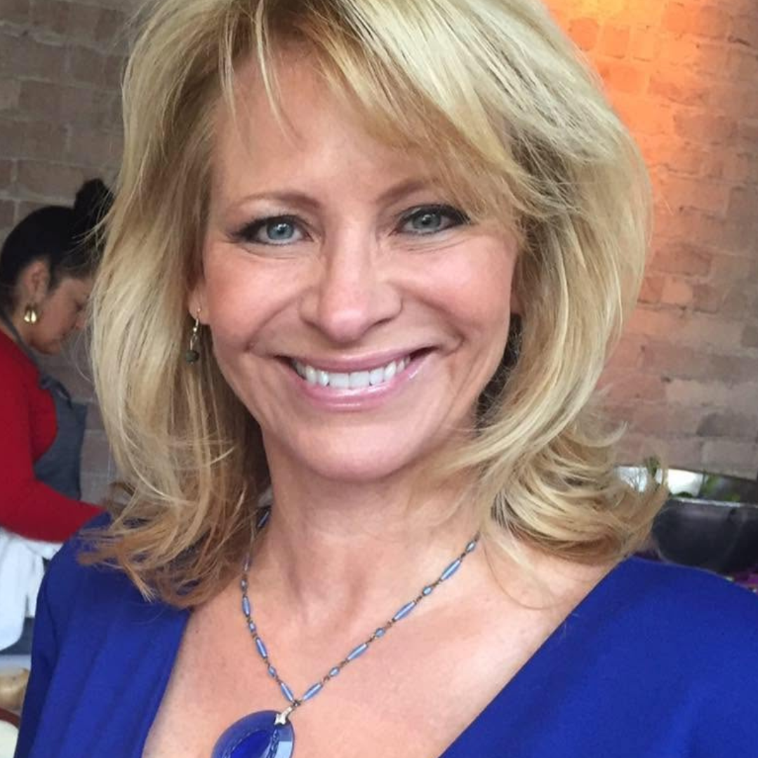 Smiling blond woman in blue dress