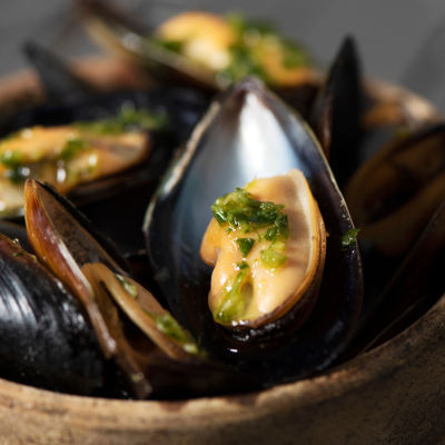 Bowl of juicy mussels with herbs